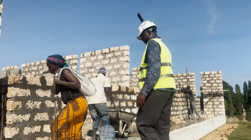 Masons building walls on site